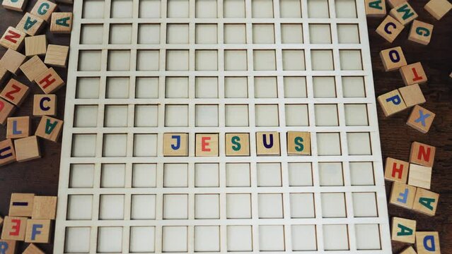 Jesus Christ. Colourful wooden square letters creating the name of Christian son of God. Bible and religion concept. . High quality 4k footage