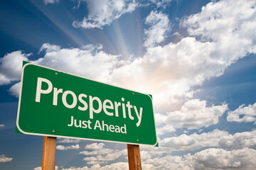 Prosperity Green Road Sign Over Sunny Dramatic Clouds and Sky.