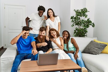 Group of young friends smiling happy having video call using laptop at home.