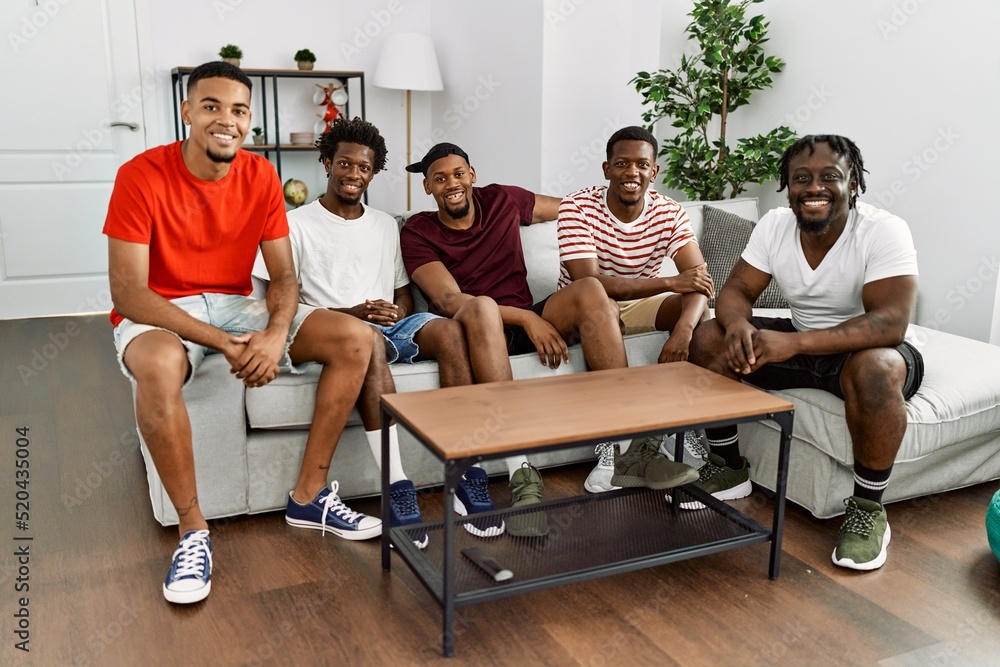 Wall mural Group of african american people smiling happy sitting on the sofa at home.