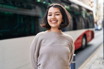 Young woman smiling confident looking to the camera at street