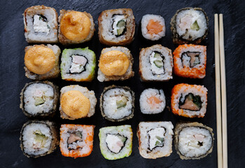 Japanese food. Sushi. Philadelphia roll with fresh salmon, cucumber, avocado, cream cheese, tobiko caviar.