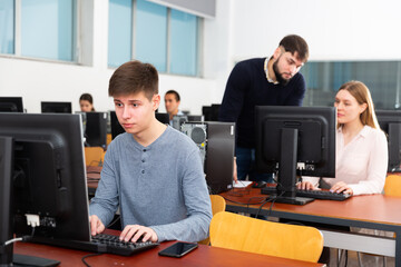 Fototapeta na wymiar Young male student works at computer. High quality photo
