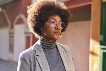 African american woman executive standing with relaxed expression at street