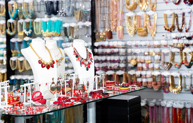 Variety of necklaces, bracelets, rings and earrings on mannequins on display in bijouterie salon