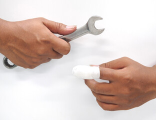 Close-up hand  Asian male technician holding a tool (wrench) is in danger. And injury to the...