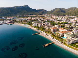 Fototapeta na wymiar Aerial photo of Kemer, seaside town in Turkey on Mediterranean coast, with view of Taurus Mountains in background.