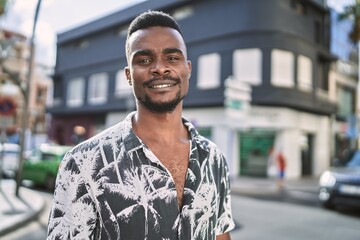 Young african american man smiling confident at street