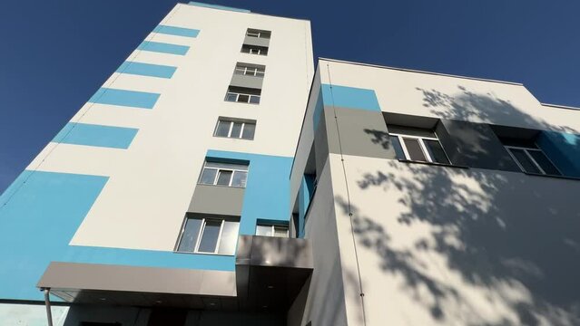 Hospital Building Exterior On A Clear Sunny Summer Day. Bottom Up View Of A Clinic Windows. Extreme Wide Angle Shot