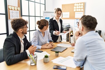 Group of young business workers listening boss speech during meeting at the office.