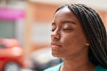 African american woman looking to the side with relaxed expression at street