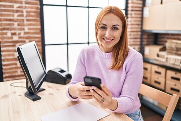 Young caucasian woman ecommerce business worker using smartphone at office