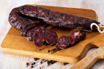 French tasty meal dry-cured sausage with liver at wooden desk, close up
