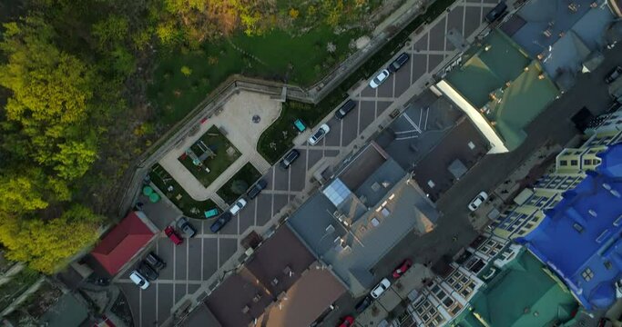 Aerial top view Kyiv roofs on the streets and bald or castle mountain at beautiful sunset or sunrise. Drone shot old Kiev - podil