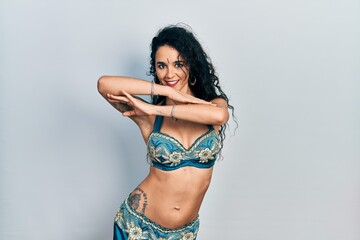 Young indian woman wearing traditional belly dancer costume. Dancing exotic oriental dance with body and hands