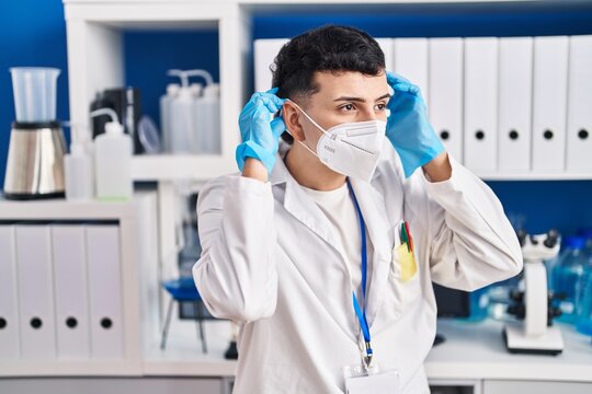 Young Non Binary Man Scientist Wearing Medical Mask At Laboratory