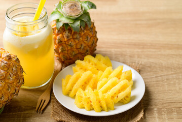 Fresh pineapple fruit and smoothie on wooden background, Summer drink