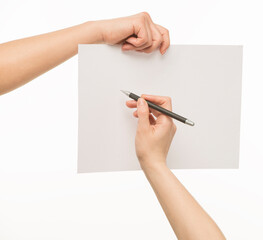 a hand with a pen writes on a clean sheet. a hand holds a pen next to a blank sheet of paper held by the other hand. Isolated on white background