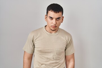 Young arab man wearing casual t shirt skeptic and nervous, frowning upset because of problem. negative person.