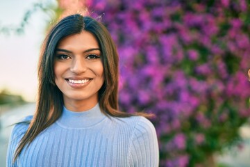 Beautiful hispanic woman smiling confient at the park