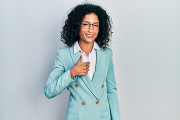 Young latin girl wearing business clothes and glasses doing happy thumbs up gesture with hand....