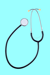 Medical stethoscope isolated on mint green background