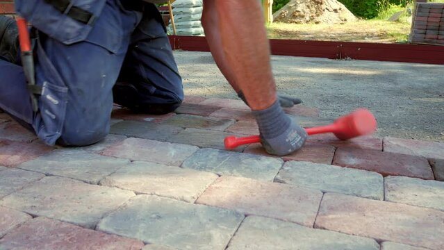 Professional paver pile up red pavestones. Handheld shot.