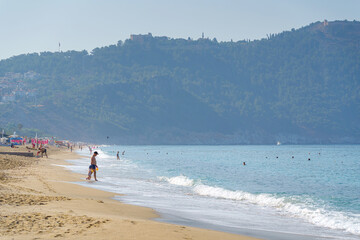 Tourists rest on the beach, Mediterranean sea, Alanya, Turkey