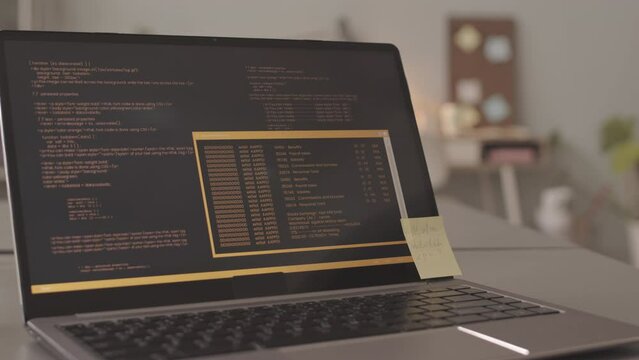 No people slowmo closeup of laptop with program codes and sticker note on screen at programmers office