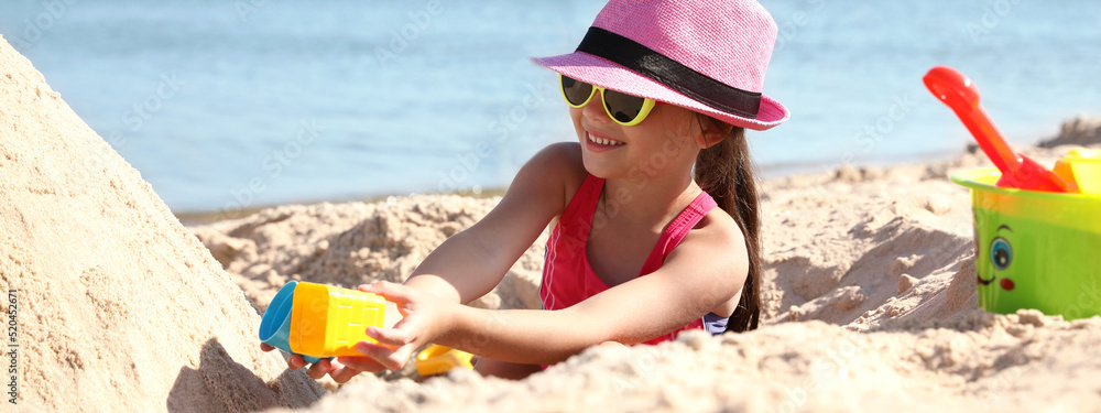 Sticker cute little child playing with plastic toys at sandy beach on sunny day. banner design