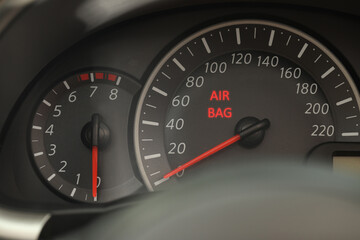 Closeup view of dashboard with warning icon check airbag system in car