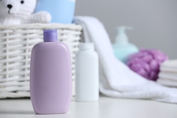 Bottle of baby cosmetic product on white table, space for text