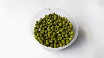 a cup of mung beans on a plain white background. Food and drink ingredients