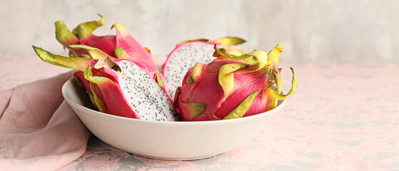Plate with tasty dragon fruit on table