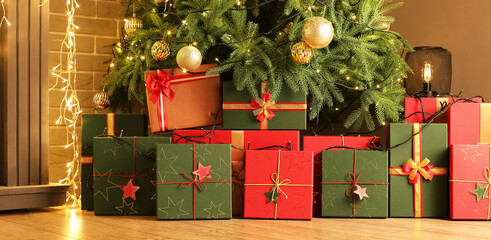 Many gift boxes under beautiful Christmas tree in living room