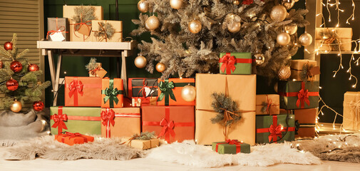 Many gifts under Christmas tree in room decorated for holiday