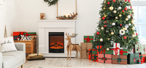 Interior of light living room with fireplace and Christmas tree with gifts