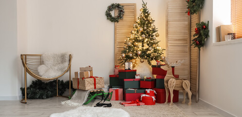 Interior of living room with beautiful Christmas tree and gifts