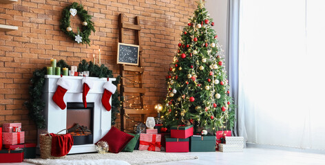 Cozy fireplace with Christmas tree and gifts near brick wall in room
