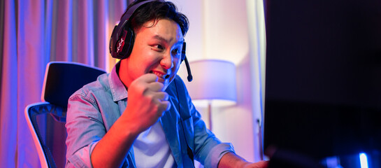 Asian attractive Esport male gamer play online video game on computer.  © Kawee