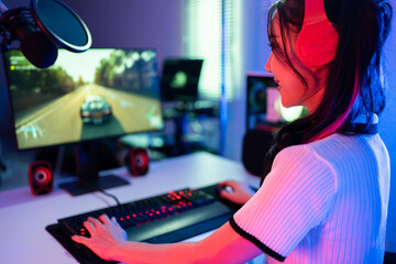 Asian beautiful Esport woman gamer play online video game on computer.  © Kawee