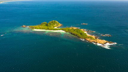Tropical island in the blue sea with a coral reef and the beach. Pigeon Island, Sri Lanka.
