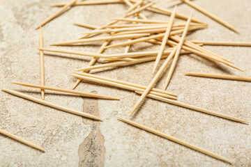 Wooden toothpicks on light background, closeup