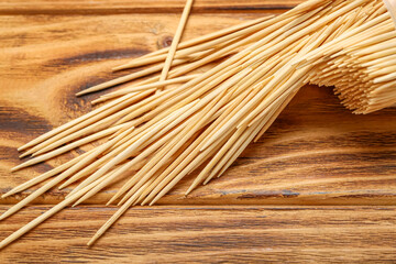 Many toothpicks on wooden background, closeup