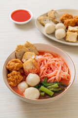 small flat rice noodles with fish balls and shrimp balls in pink soup, Yen Ta Four or Yen Ta Fo