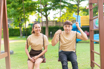 Asian couple love play on the swing