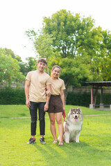 Naklejka na ściany i meble Asian couple love with dog
