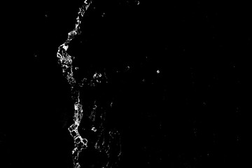 water splashes isolated on black background. white jets with drops