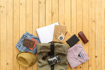 Male accessories for travelling with bag on wooden background