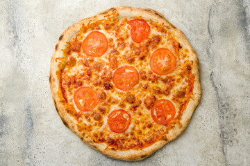 Italian pizza Margherita with cheese and tomatoes top view on stone table, margarita
